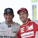 Race winner Lewis Hamilton (GBR) Mercedes AMG F1 and Sebastian Vettel (GER) Ferrari celebrate on the podium with the trophies at Formula One World Championship, Rd14, Japanese Grand Prix, Race, Suzuka, Japan, Sunday 27 September 2015. &copy; Sutton Motorsport Images